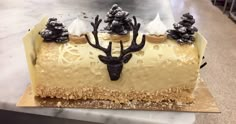 a cake with frosting and decorations on top of a counter in a store or restaurant