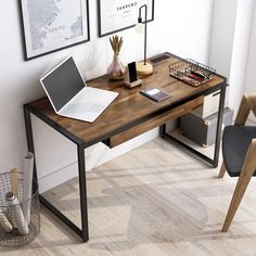 a laptop computer sitting on top of a wooden desk next to a lamp and chair