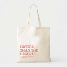 a tote bag that says,'hotter than the desert'on it