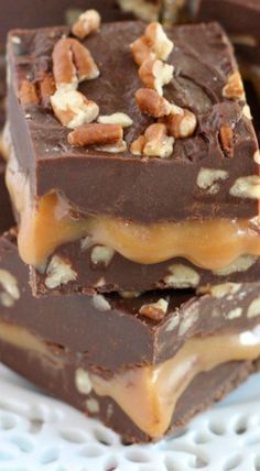 three pieces of chocolate fudge with nuts on top