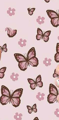 a teddy bear sitting in front of a pink background with butterflies