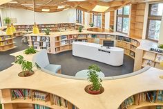 an aerial view of a library with bookshelves, desks and planters