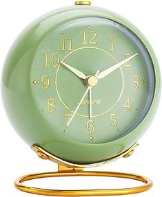 a green alarm clock sitting on top of a metal stand