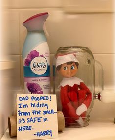 an elf is sitting on the counter next to a bottle of deodorant