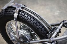 a close up view of the front tire and spokes on a motorbike