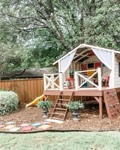 there is a small play house in the back yard with a slide and climbing wall