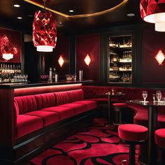 a red and black room with some wine glasses on the bar stools in front of it