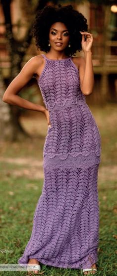 a woman in a purple crochet dress posing for the camera with her hand on her hip