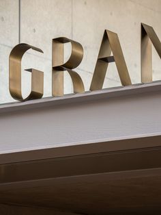 a sign that says gran on the side of a building with metal letters above it