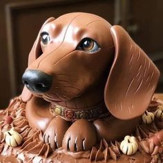 a chocolate dog cake with icing on it's face and paws in the shape of a dachshund