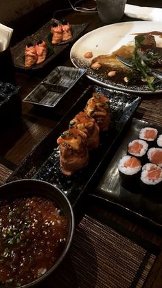 sushi and other foods are on the table ready to be eaten at this restaurant