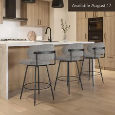 three stools in front of a kitchen island