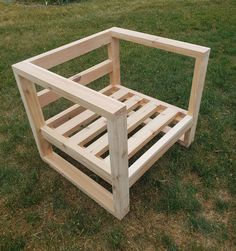 a wooden bed frame sitting in the grass