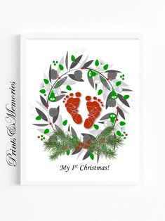 a christmas card with two baby footprints in a wreath