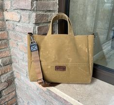 a brown bag sitting on top of a window sill next to a brick wall