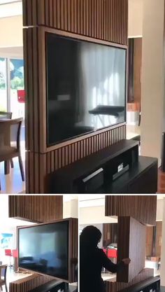 a woman standing in front of a flat screen tv next to a dining room table