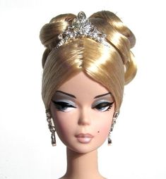 a barbie doll with blonde hair wearing a tiara and earrings on it's head