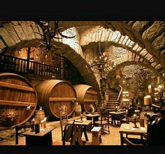 an old wine cellar with wooden barrels and tables