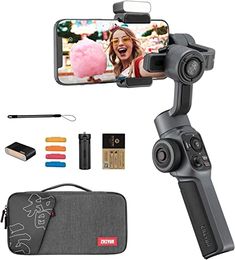 an image of a cell phone with a camera attached to it and other items surrounding it