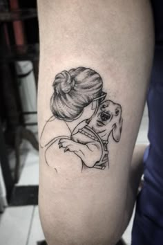 a woman with a dog tattoo on her leg