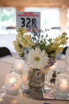 a table with flowers and candles on it for a wedding or special event centerpiece