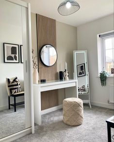 a bedroom with a vanity, mirror and stool in it