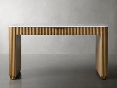 a wooden table with a white marble top and gold trimmings on it's legs