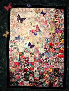 a quilted wall hanging with many different colored butterfly designs on it's sides