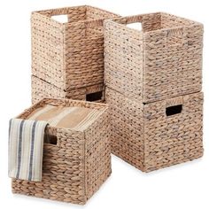 three woven storage baskets with towels in them