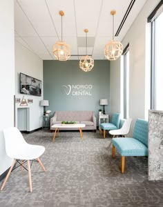 an office waiting area with chairs and couches