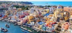 an aerial view of the colorful buildings and boats in the water