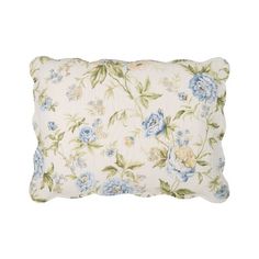 a white pillow with blue and green flowers on the front, sitting against a white background