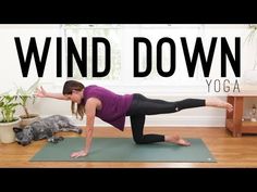 a woman doing a yoga pose with the words wind down above her and an image of a cat