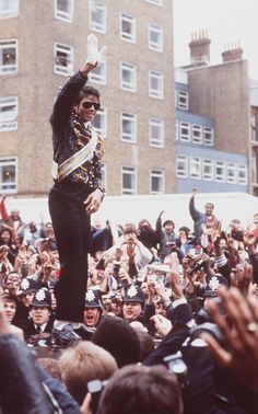 a man in uniform standing on top of a crowd