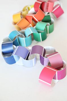 several different colored bracelets on a white surface