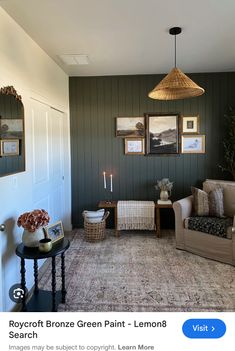 a living room filled with furniture and pictures hanging on the wall above it's doorway