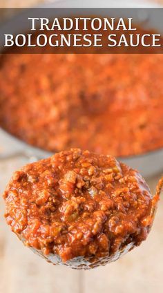 a spoon full of chili sauce with the words traditional bolognaise sauce above it