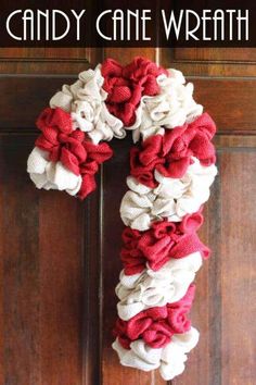 a candy cane wreath hanging on the front door with text overlay that reads, candy cane wreath