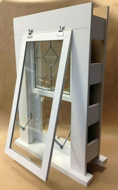 a white display case with two glass doors on the front and bottom sides, open