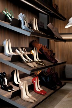 there are many pairs of shoes on the shelves