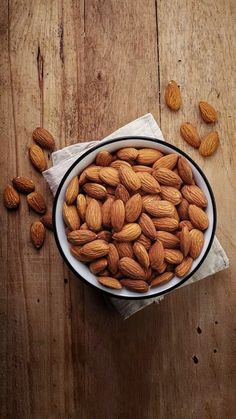 almonds in a bowl on a wooden table