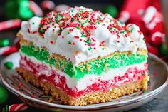 a piece of cake with white frosting and colorful sprinkles on top