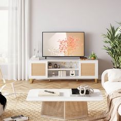 a living room with white furniture and a flat screen tv