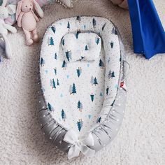 a baby crib is laying on the floor next to stuffed animals