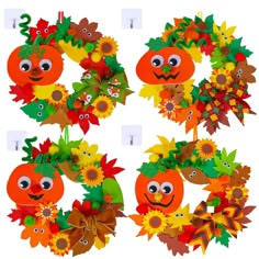 four wreaths with faces and leaves on them