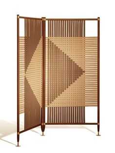 a room divider made out of wickers and metal rods with an abstract design