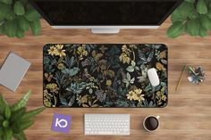 an overhead view of a desk with a computer, keyboard and mouse on it next to a potted plant