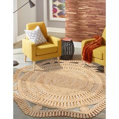 a living room with two yellow chairs and a round rug on the floor in front of a brick wall