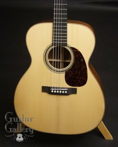 an acoustic guitar is displayed on a black background