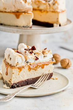 a piece of cheesecake on a plate with a fork in front of the slice